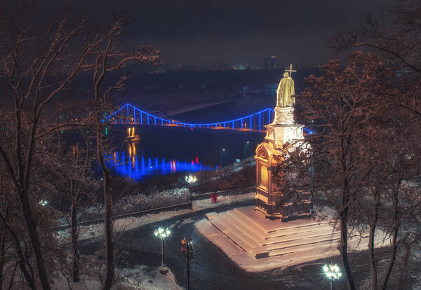 Scenic view of Saint Vladimir Monument against the backdrop of the Dnieper River at winter night, Kyiv (Kiev), Ukraine. Saint Vladimir Monument is popular touristic symbol of Kyiv, capital of Ukraine
