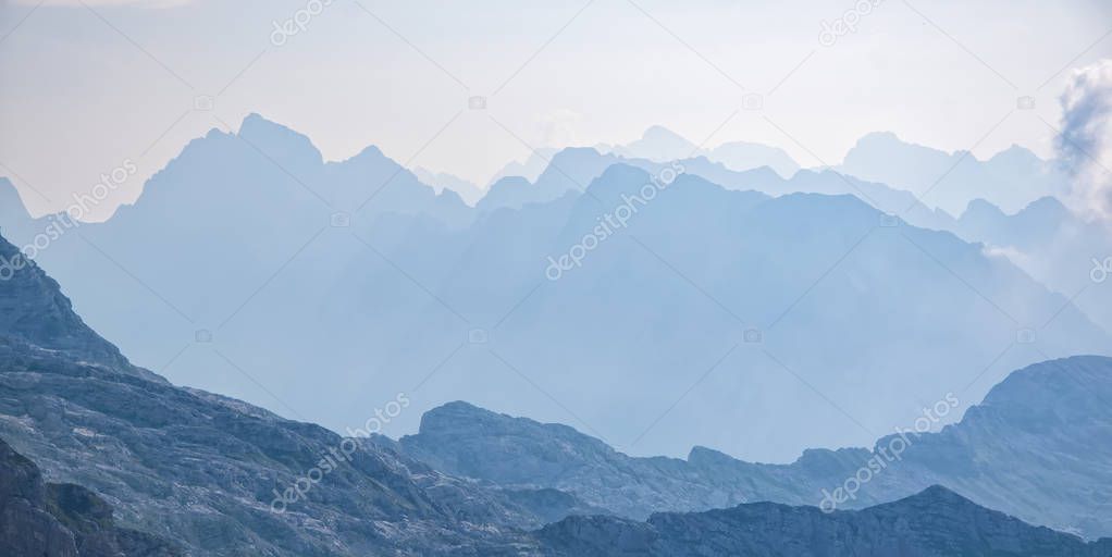Scenic view of blue ridge in hazy mountains. Julian Alps, Slovenia