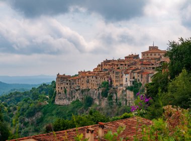 Panoramic view of Tourrettes-sur-Loup town in Provence, France. It is a medieval village, perched on a rocky spur, popular tourist attraction known as 'village perches' (village-fortress) clipart