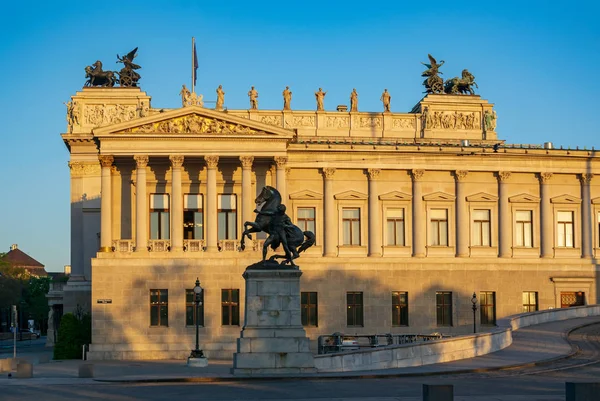 Right side of Parliament building in Vienna, Austria in sunrise light. Greek Revival architecture style. Parliament building is a notable Viennese tourist attraction