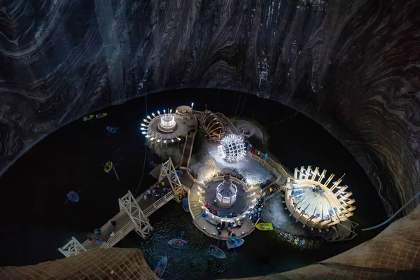 Futuristic view of pier for tourist boats on underground lake in Salina Turda salt mine, Romania — Stock Photo, Image