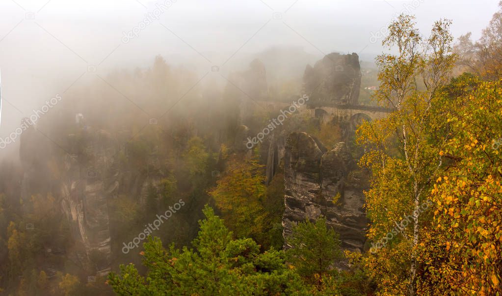 Amazing scenery of the Bastei bridge, Saxon Switzerland National Park, Germany. Autumn foggy day