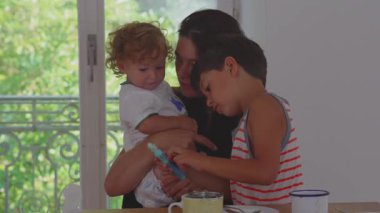 İki çocuklu anne neşeli bir bağ kuruyor. Renkli bir kaleme, sıcak bir aile bağına ve evde mutlu vakit geçirmeye bakarken birlikte gülüp gülüyorlar..