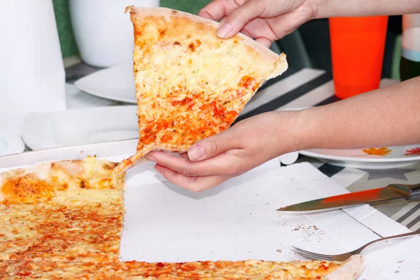 Hands taking slices of pizza Margarita. Hand drawn on pieces of delicious pizza, close up. Italian traditional classic pizza being held in box. Fast Food. Enjoying great tastes of Italian cuisine.