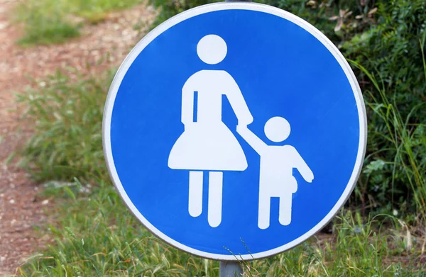 Sign or symbol for pedestrians. Warning road sign of blue sign baby take care when walk across the road symbol. Traffic sign with pedestrians in nature. Pedestrian sign. Forbidden and warning signs.