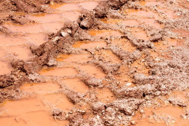Yol, su birikintisi ve çamur yağmur sonra tekerlek izleme. İzleme toprak traktör, tarak, Araba, otomotiv lastik çamurlu yolda izler. Yağmurlu bir gün göletlerde olan Sandy yol ülkede. Arka plan, doku.