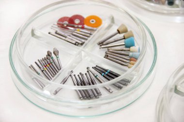 Diş matkap mermilerin. Diş ekipman, matkaplar, aşındırıcılar, diş bur Lehçe bur Petri kabına cam içinde yuvarlak yüzey taşlama, kanallar için. Araçları iş dişçi için. Diş Hekimliği için belirli Tıbbi aygıtlar.