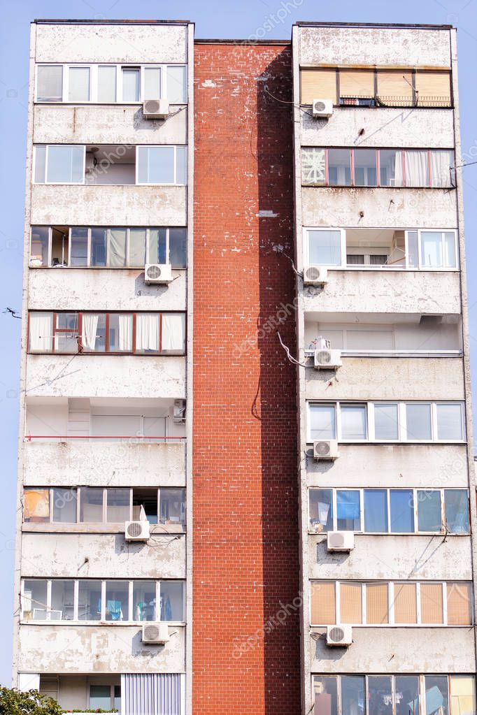 Communist socialist architecture. Architectural detail and pattern of social residential of apartments. Portrait of socialist-era housing district, city building facade. Old apartment windows in city.