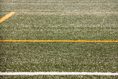 Part of sport soccer stadium and artificial turf football field. Detail, close up of green grass with white lines, goal line, corner line. Focus football field selected background, texture, wallpaper.