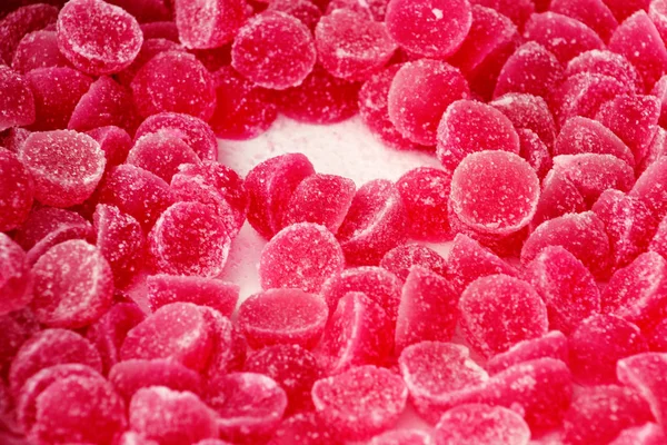 Many gelatin sweet red strawberries fruit candy candies sugar. Assorted color jelly sweets. Pile of colored confectionery for kids. Delicious gummy candies fruit flavor of blackberry and raspberry.