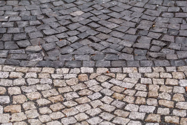 Cobblestones, pavement. Stone pavement texture. Granite patterned cobblestoned pavement floor background. Abstract background of old cobblestone pavement close up. Stone path at old town in Europe.