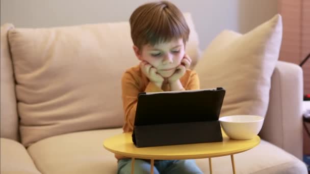 Child Using Tablet Bed Home Cute Boy Sofa Watching Cartoon — Stock Video