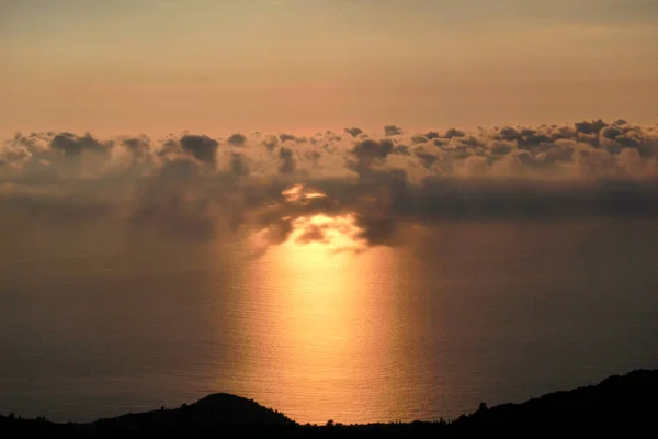 Sea, sky, beautiful structure of clouds, majestic landscape with seascape at calm sunset on horizon of mediterranean coast. Amazing sunset vibes on edge ocean. Sunrise over sea, natural environment.