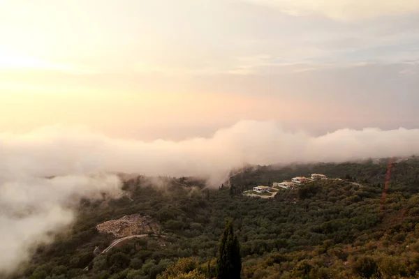 Beautiful structure of clouds on sky, mountain landscape with dense fog at sunset on horizon of beauty natural environment. Panorama of amazing sunrise view show sun rays through clouds over mountain.