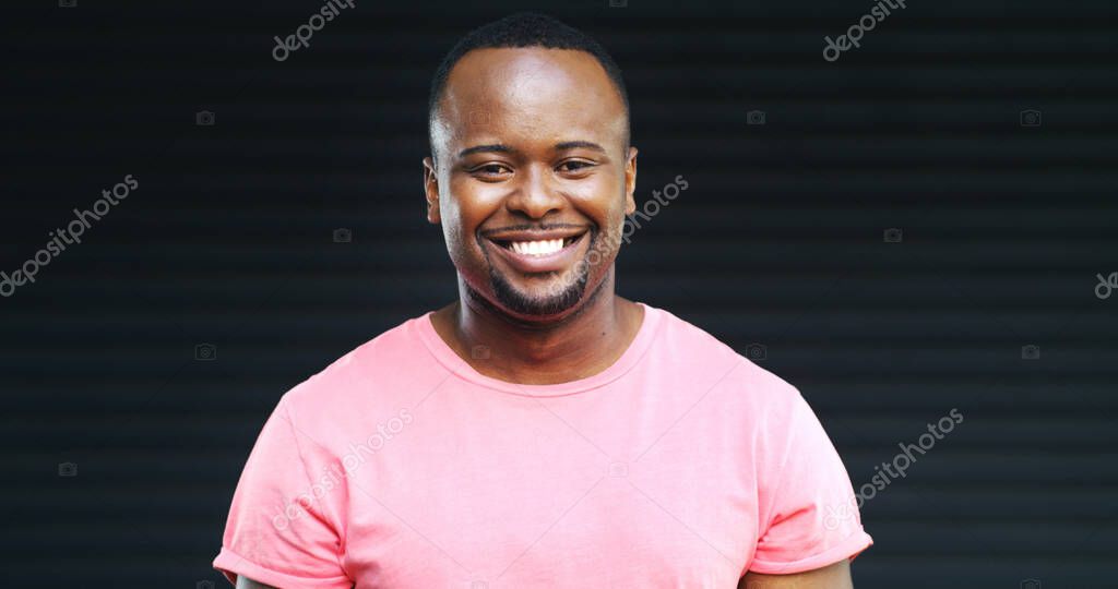 Happy, black man and portrait with fashion in studio for positive attitude on a dark background. Face, male person or African model with smile, pink tshirt or friendly expression on mockup space.