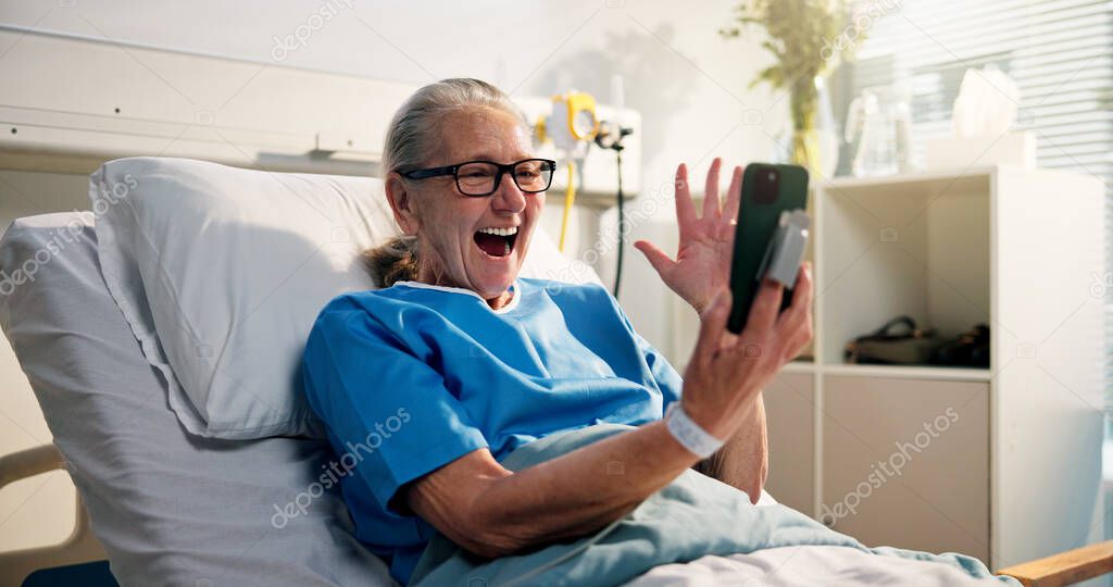 Senior woman, phone and video call in hospital bed with wave, surprise or get well soon message. Person, smartphone and virtual contact on social media with rehabilitation, hello or chat at clinic.
