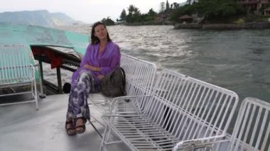 Bir kadın gölde tekne ile yolculuk