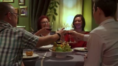 Arkadaşlar sit Restoran kodes gözlük ve içki kırmızı şarap bir masada Grup