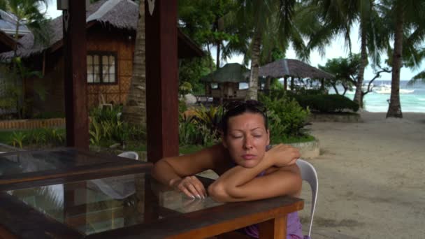 Een vrouw zit op een receptie op het terras — Stockvideo