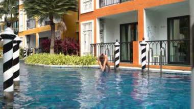 Bir kadın bir mayo içinde merdiven dalışı ile havuz