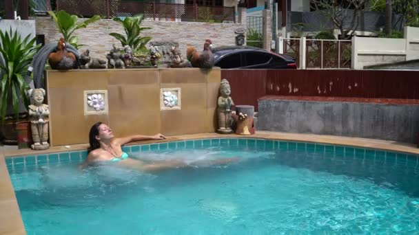 Una donna si siede in piscina con vasca idromassaggio — Video Stock