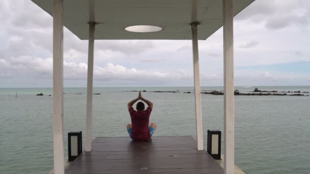 Man is engaged in meditation by the sea
