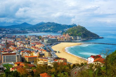 San Sebastian - Donostia city, Basque country, Spain, view of the Zurriola beach, Urgull mount, La Concha bay, surrounding Pyrenees mountains and Atlantic ocean clipart