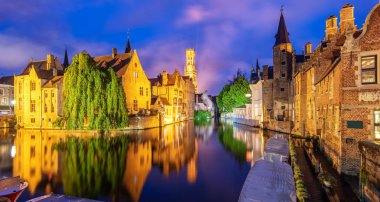 Panoramic view of the Rozenhoedkaai canal, historical brick houses and the Belfry in Bruges medieval Old Town, Belgium, a UNESCO World Culture Heritage site clipart