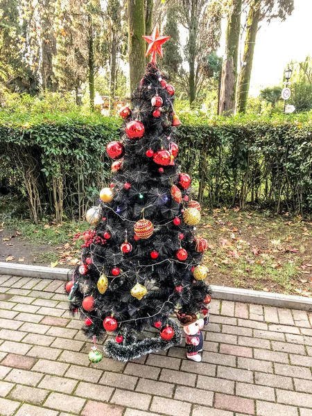 Christmas tree on the street. decorated with beads.