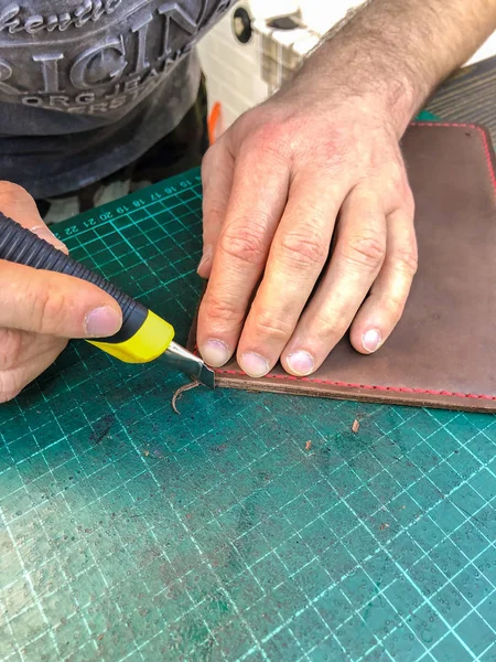 the master of leather products makes does the work. Leather goods.