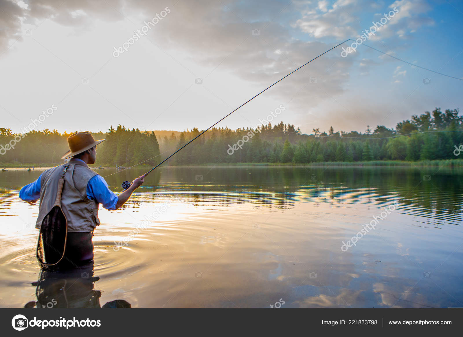 Young Man Flyfishing At Sunrise Stock Photo - Download Image Now