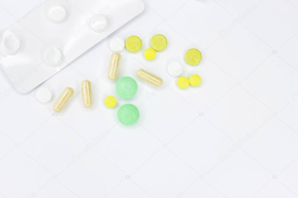 Pills for treatment. Pills on a white background for the announcement. Place for text on medetsine. Background or texture. Fasting on the Internet.