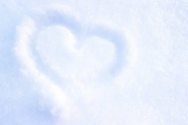 Heart drawing on the snow. We draw on the snow love.