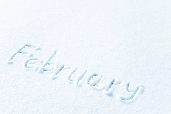 The inscription on the snow, the months of winter. February, the winter month.