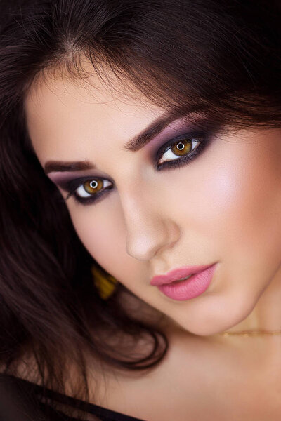 Pretty oriental look. Sensual brunette model. Close-up portrait of arabic woman. Creativity bright make-up long volume dark hair.