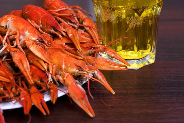 Boiled cooked crayfish crawfish ready to eat on black background. Copy space. Overhead.