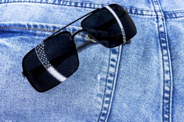 Güneş gözlüğü ile jeans cep closeup. Arka plan veya doku.