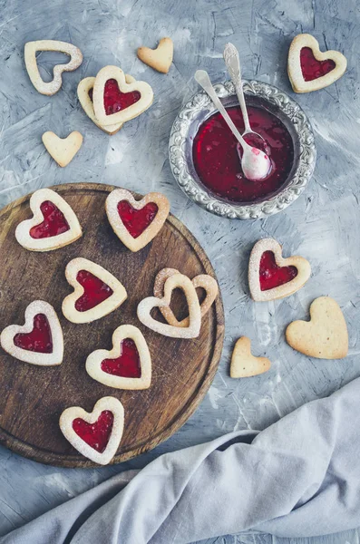 Heart shaped Linzer cookies with jam for Valentine\'s day. Delicious homemade pastry. Baking with love concept. Top view.