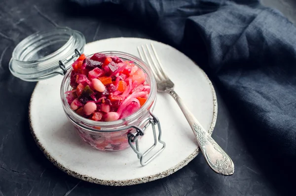 Healthy salad Vinaigrette with pickled cucumbers and sauerkraut, potatoes, carrots, beetroot and onions. Vegan cuisine. Fermented food. Probiotic sources. Traditional Eastern Europe food.