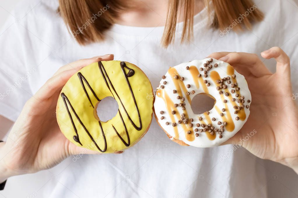 Close up portrait of a girl holding donuts