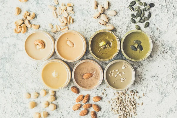 Nuts and seeds butter in glass jars — Stock Photo, Image