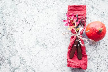 Şükran Günü sonbahar sofra takımı ve gri arka planda sonbahar yaprakları. Şükran Günü yemeği konsepti. Mevsimlik davetiye ve menü için maket. Üst Manzara. Boşluğu kopyala.