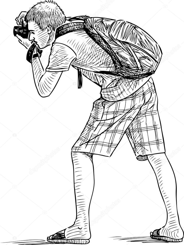 Sketch of a young man shooting on his camera