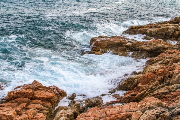 海岸の崖に衝突して泡沫の青い波 — ストック写真