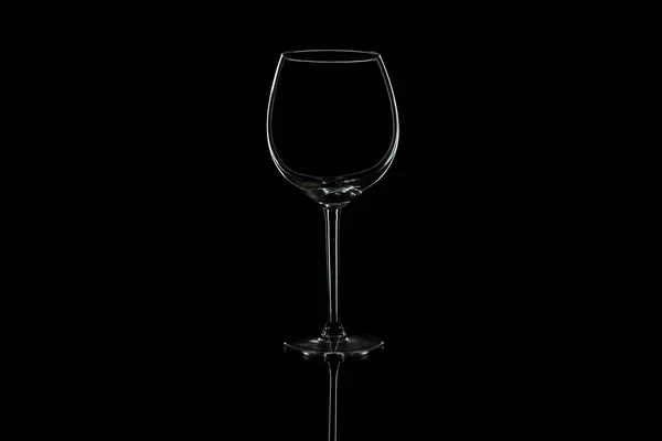 Wine glass on a black isolated background with reflection