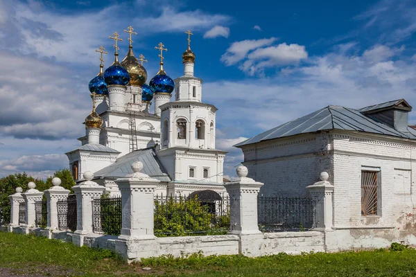 Old white stone Orthodox church with glittering colored domes