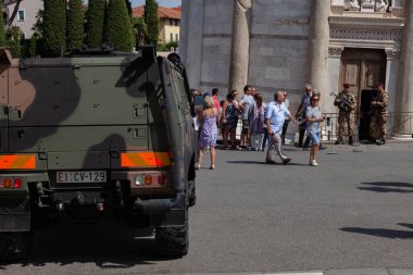 PISA, ITALY - AUGUST 31, 2017: Armed military assault rifles guard the entrance to the Leaning Tower of Pisa. In camouflage coloring