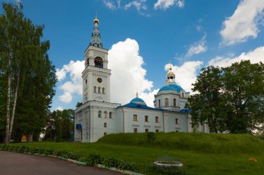 Picturesque Orthodox church on the territory of the monastery on a background of blue sky with white clouds