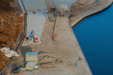 MOSCOW, RUSSIA, - December 20, 2019: Workers lay paving slabs on the Moskva River embankment