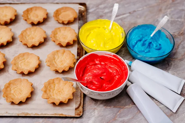 Pastry bags with colored cream inside. Food colorings. The process of making cream colored cream for tart tarts. Cream staining with food coloring. Tubes with dyes.